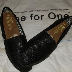 Tom's black sparkly slipons